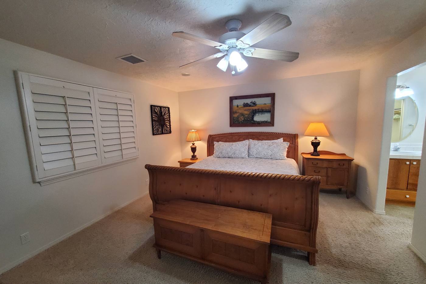 Master suite — king bed, plantation shutters
